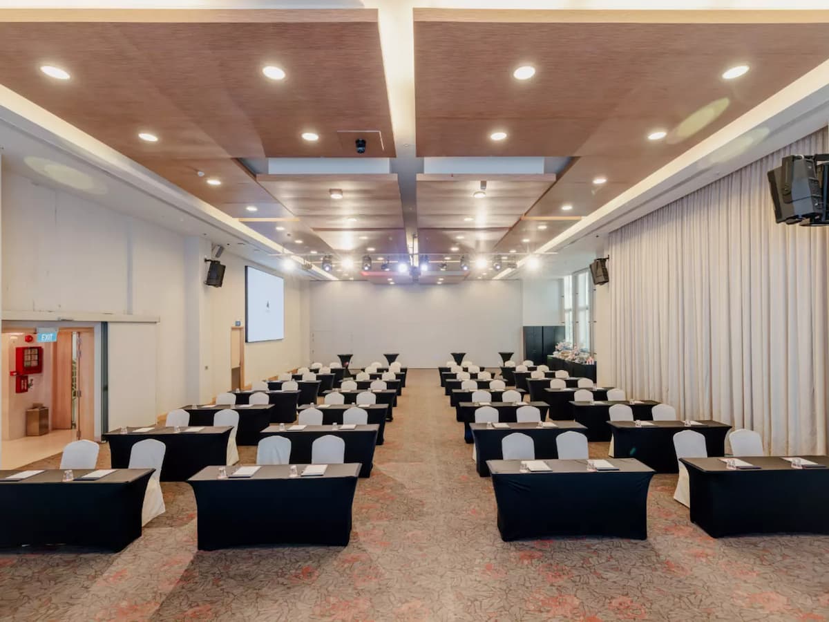 Conference hall with classroom-style seating and professional presentation setup.