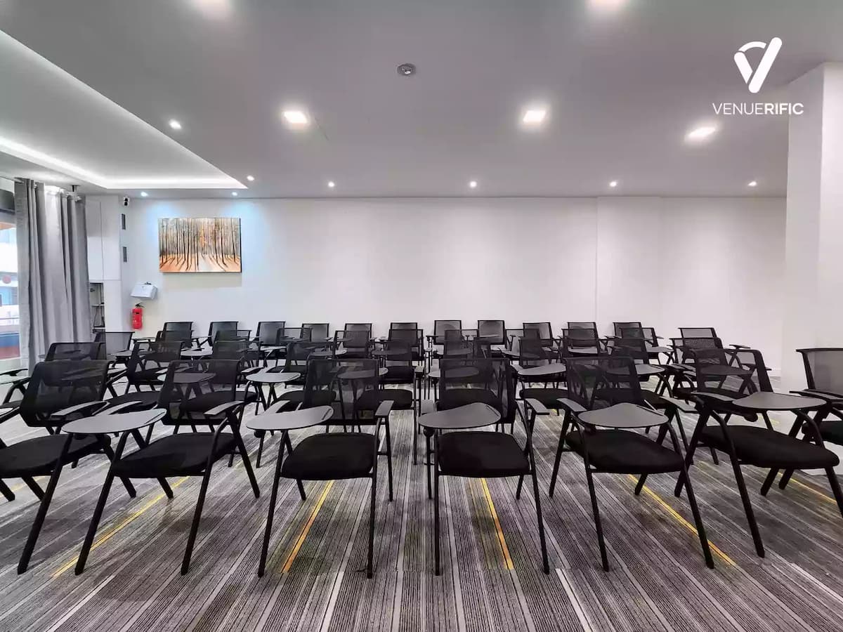 Modern training room with rows of black mesh chairs.