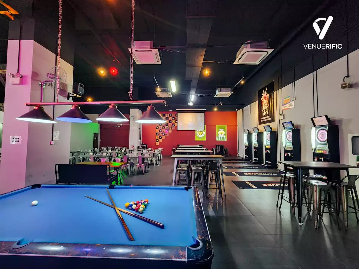 Darts and pool venue with gaming tables, electronic boards, and casual seating.