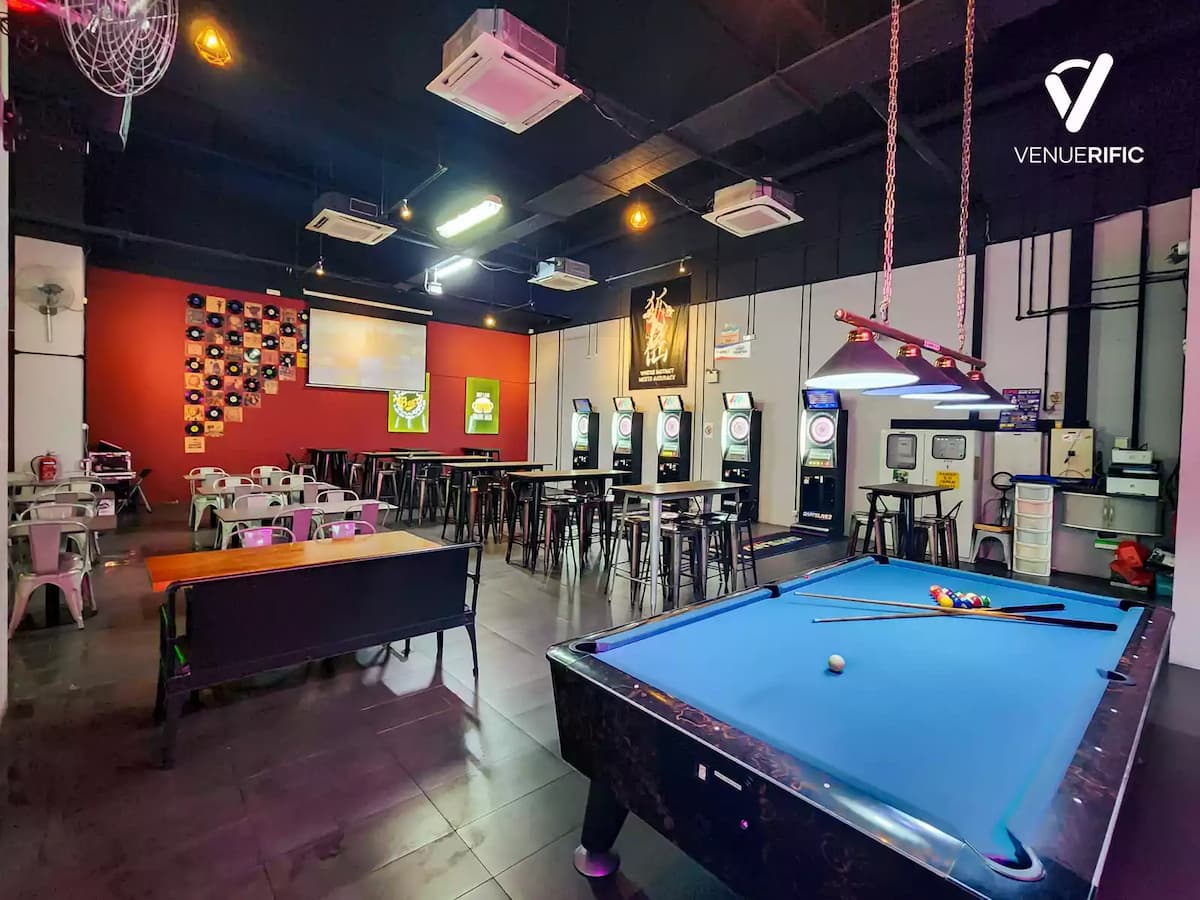 Casual gaming bar with pool table, electronic darts, and communal seating.
