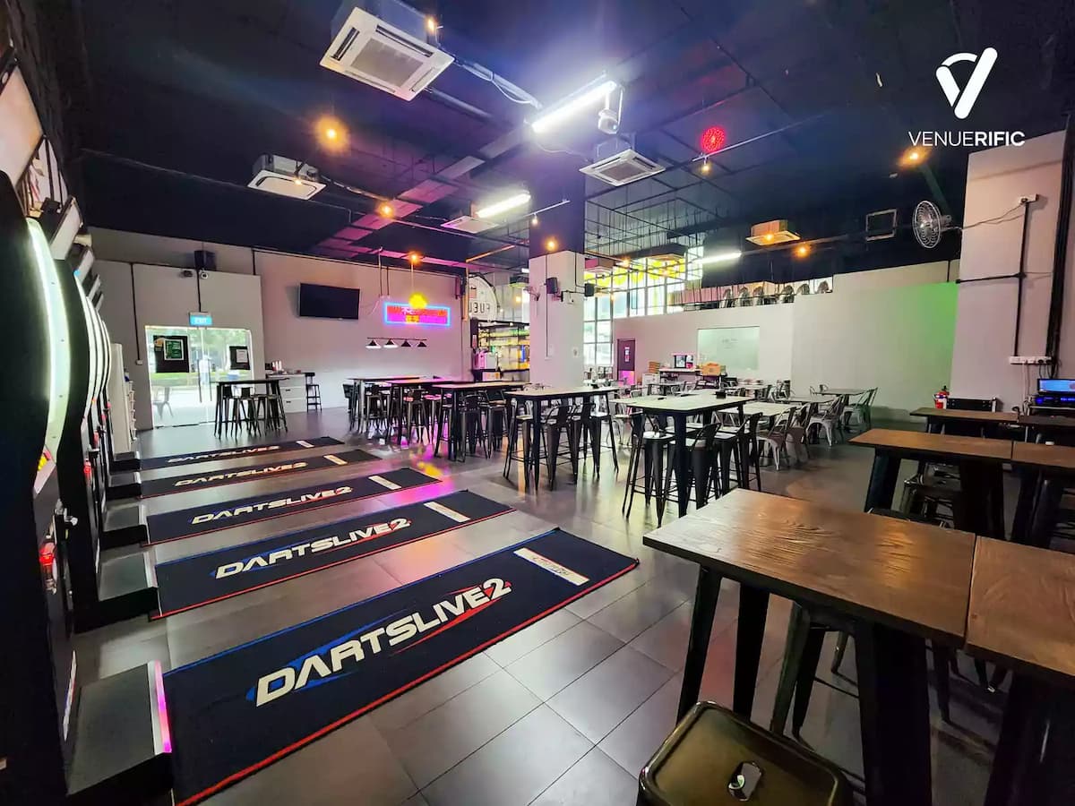 Casual darts venue with electronic boards, high tables, and open layout.