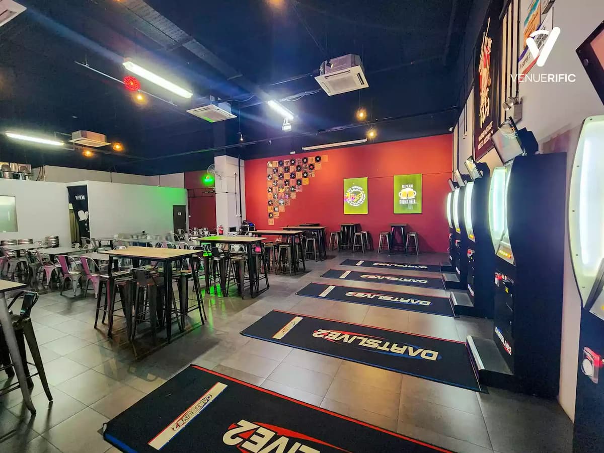 Spacious darts bar with electronic boards, high tables, and casual seating.