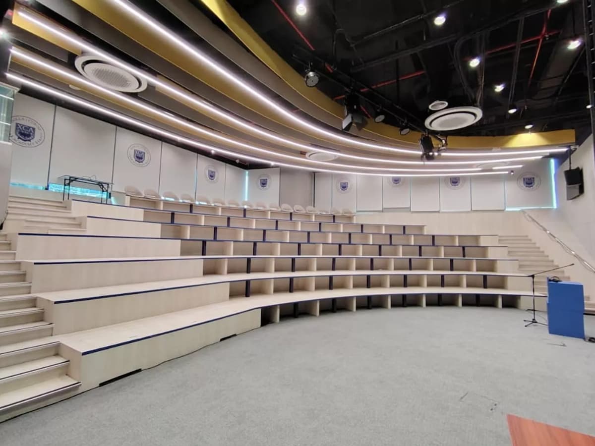 wide view of empty tiered auditorium seating from the stage at a town hall event venue near mid valley
