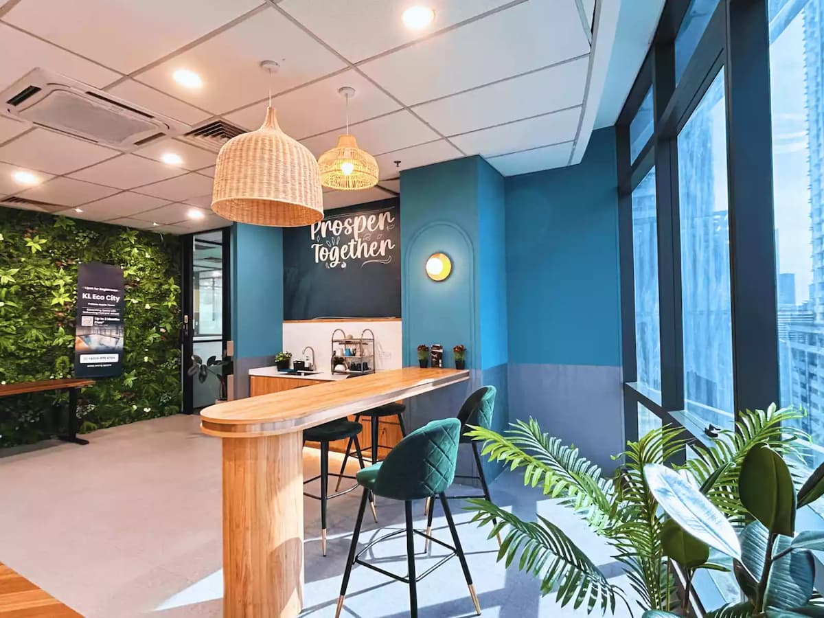 coffee bar lounge with green plant wall rattan pendant lights and city view for networking events at bangsar kuala lumpur