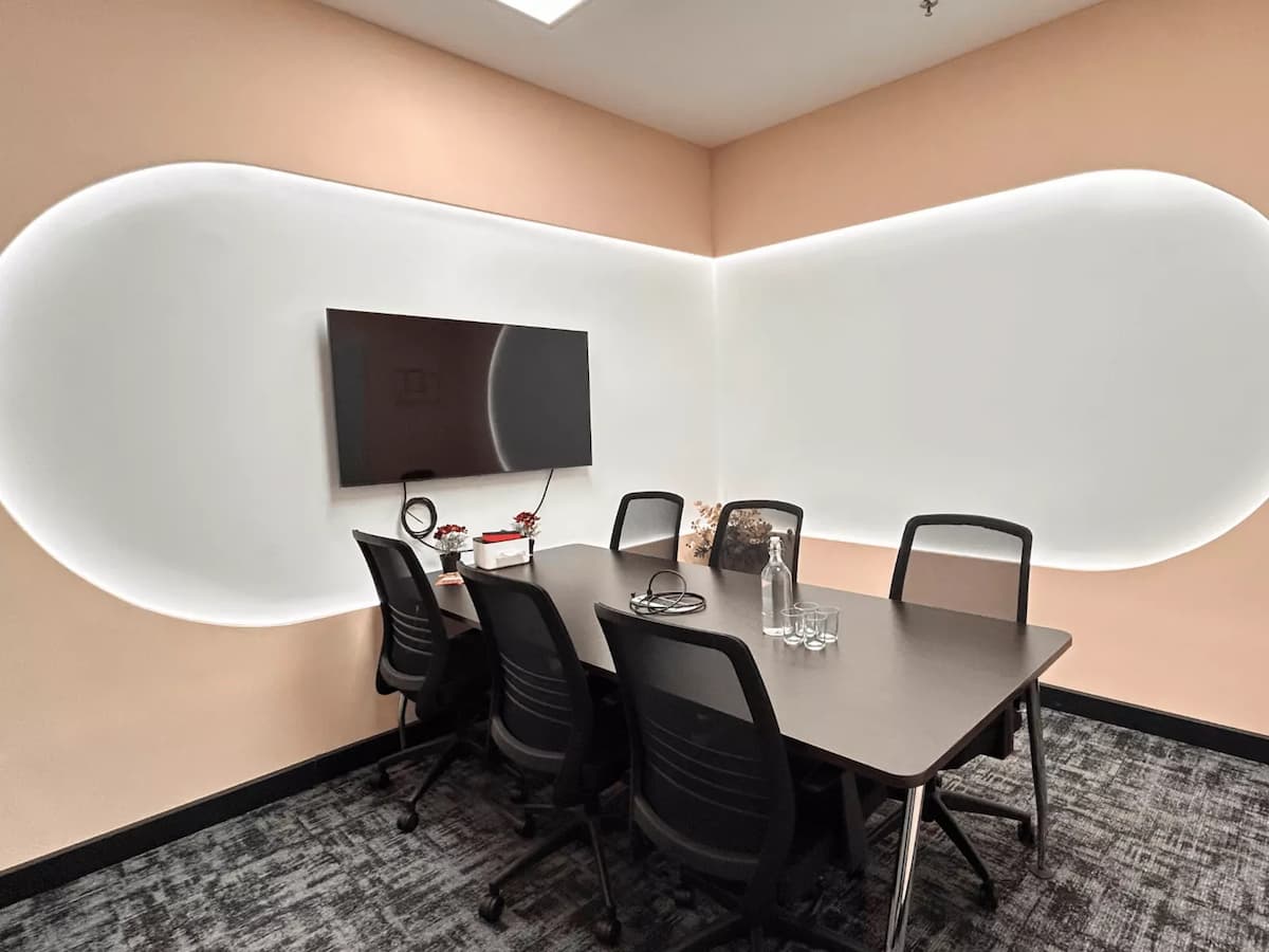 small meeting room with six seats and a wall mounted television screen for team discussions at event venue in bangsar kuala lumpur