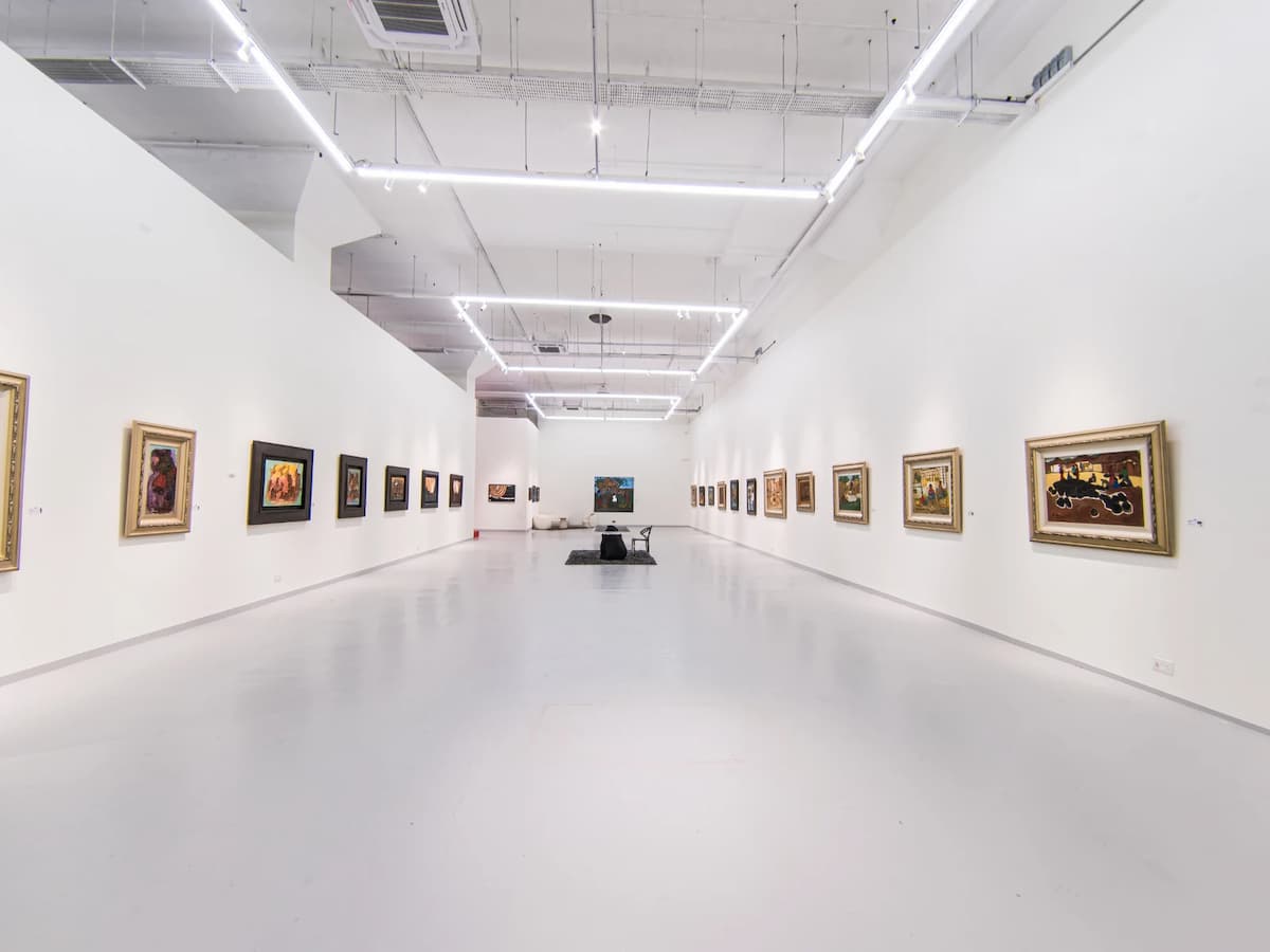 spacious exhibition hall with all-white walls and polished grey floor