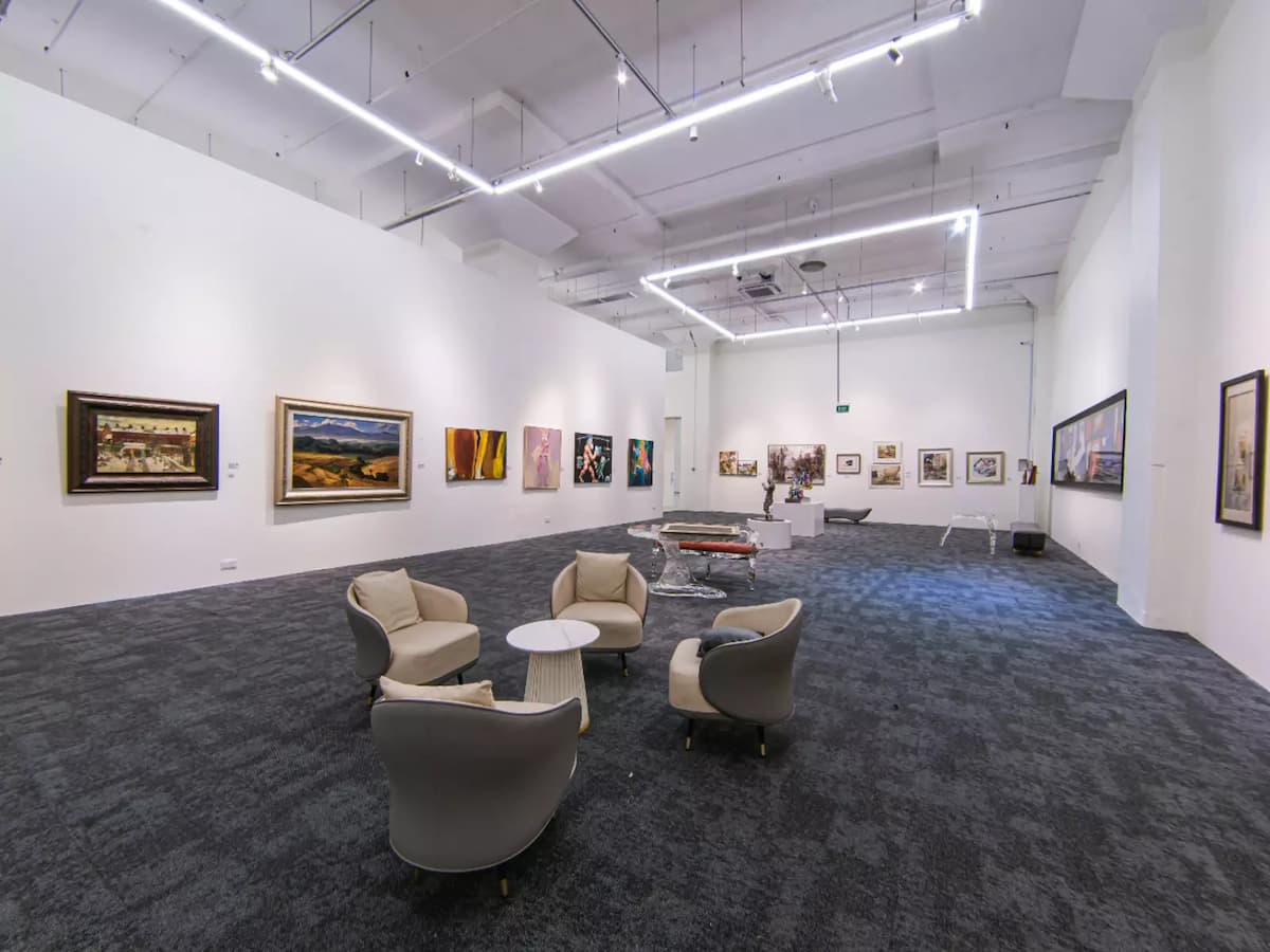 Art gallery event space with exhibition walls and lounge seating.