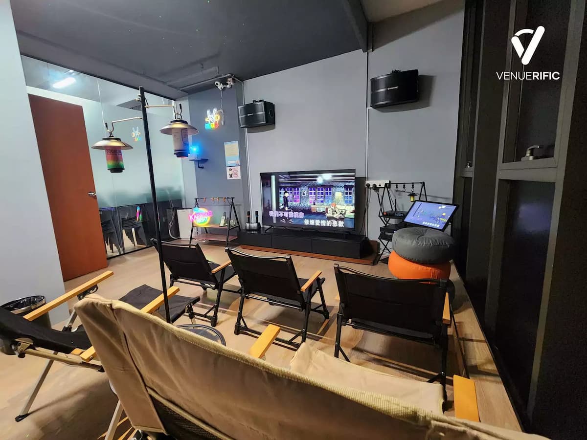 Cozy screening or gaming room with lounge chairs, TV setup, creative lighting, and a relaxed, casual vibe.