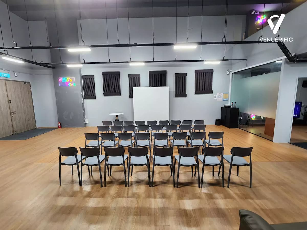 Classroom-style event setup with rows of chairs, a presentation screen, and a clean, modern interior.