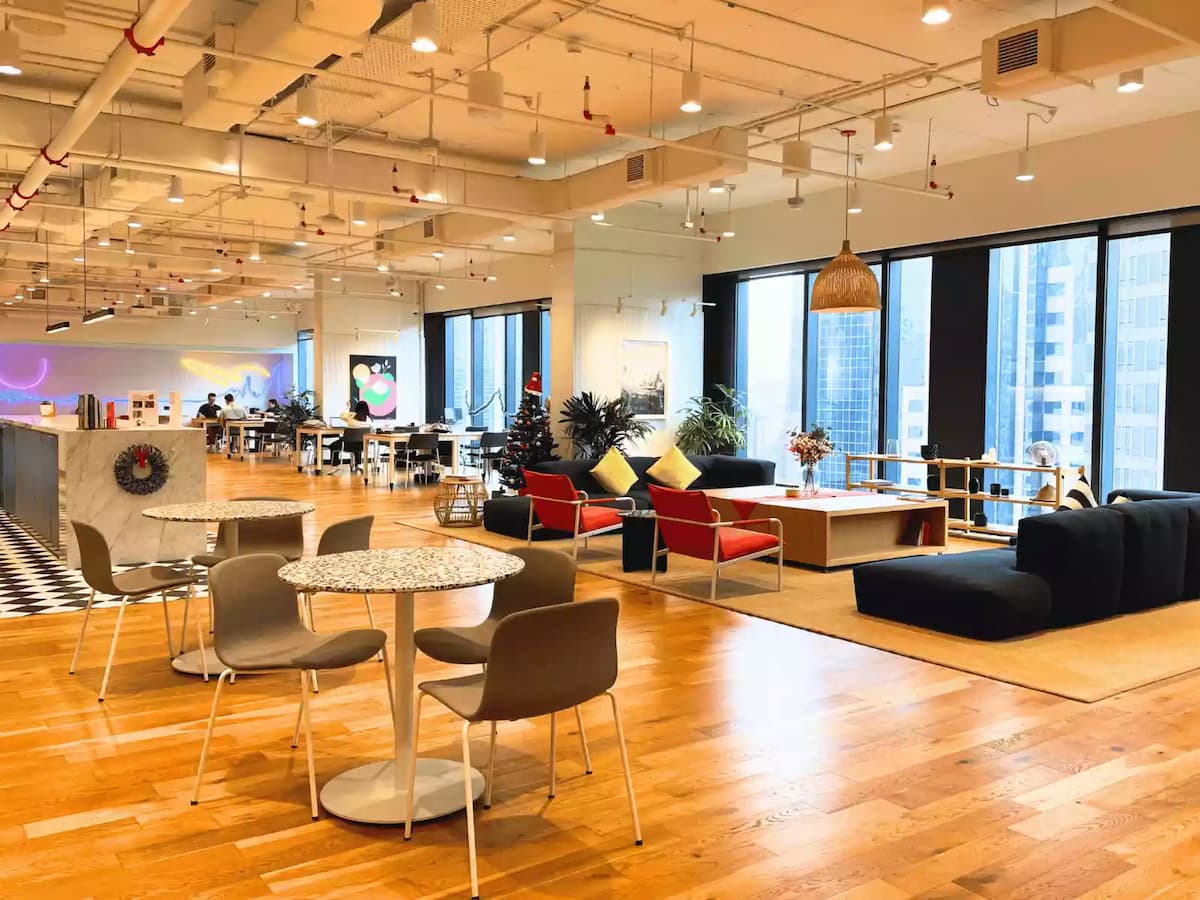 bright coworking lounge with casual seating and city views at wework equatorial plaza event venue kuala lumpur