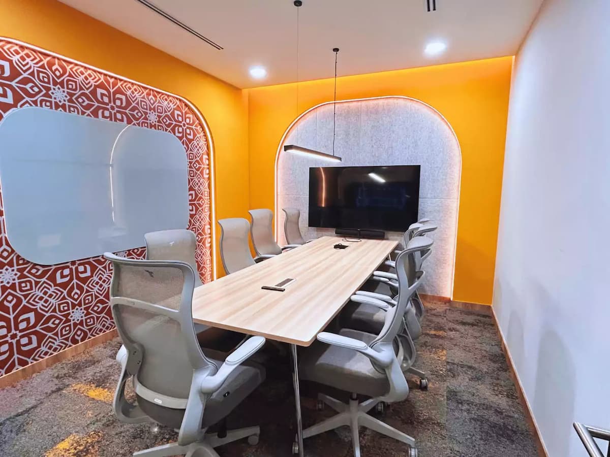 bright orange conference room with whiteboard and television screen offering an affordable place for meetings at central kl meeting room in malaysia