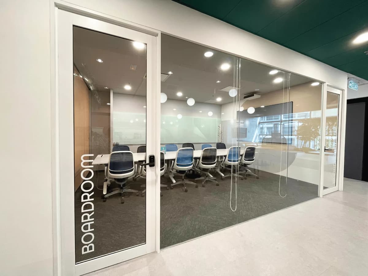 glass door entrance with boardroom signage leading into a corporate meeting space with a long conference table at kl eco city kuala lumpur