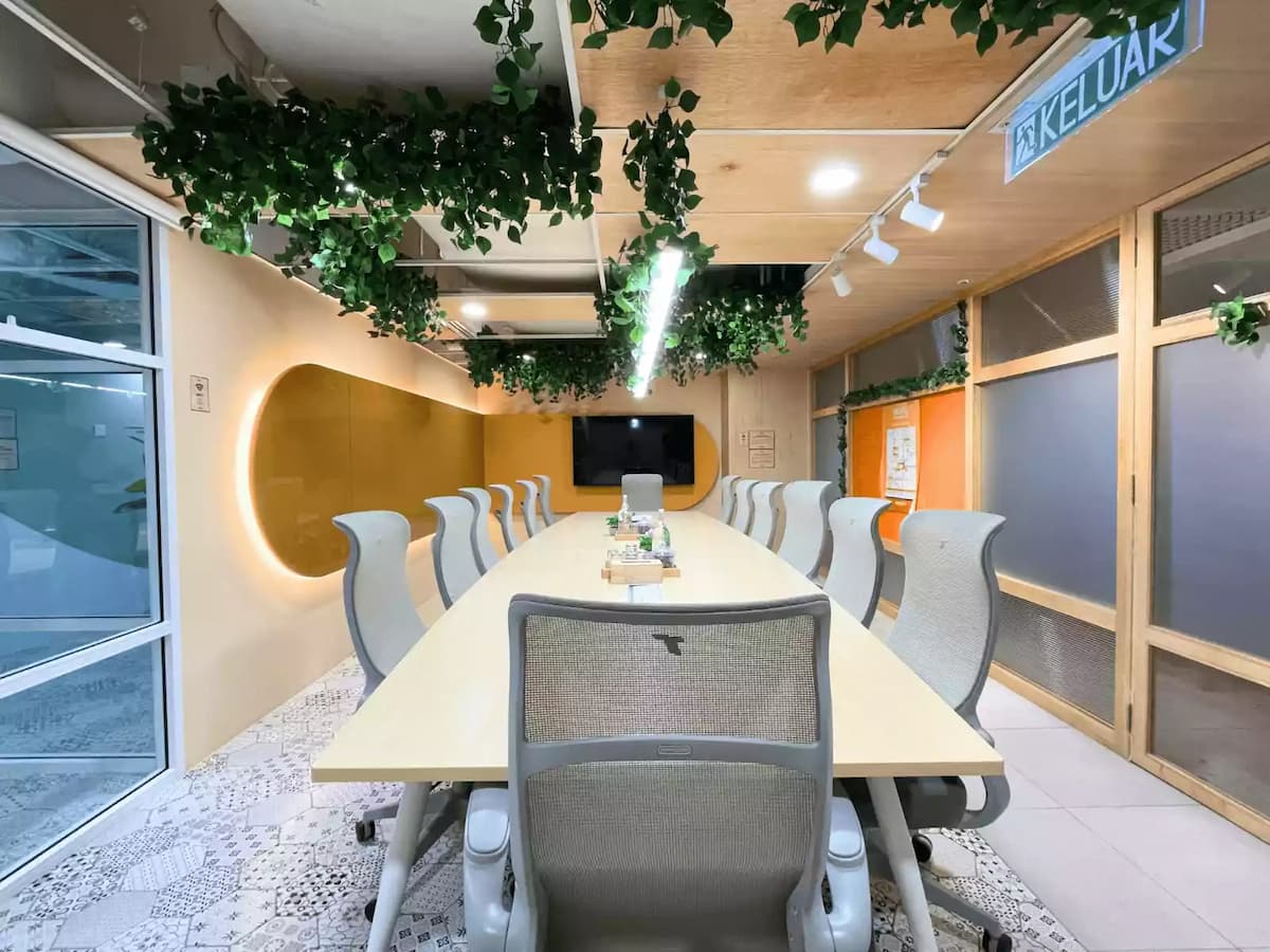 conference room seating twelve people with pale wood table led wall panel and television screen at a workshop venue in kuala lumpur