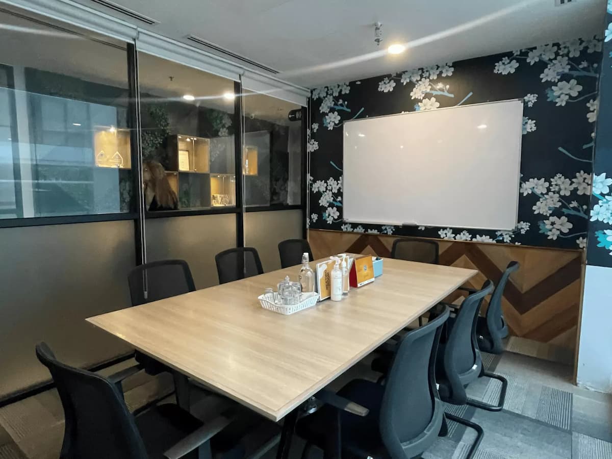 conference room with wooden table whiteboard and refreshments set up for team meeting at event space in subang