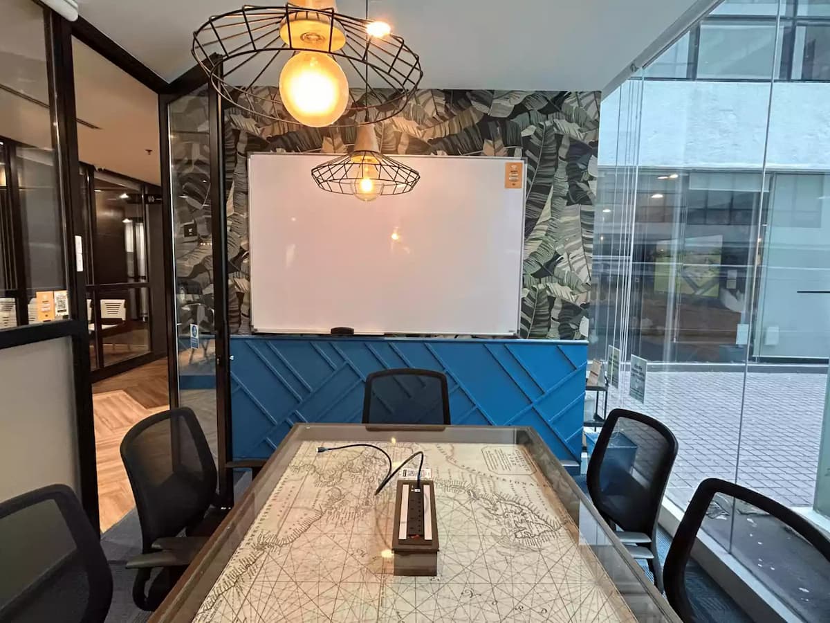 meeting room seating six with whiteboard pendant lights and map top table at workshop space in subang selangor