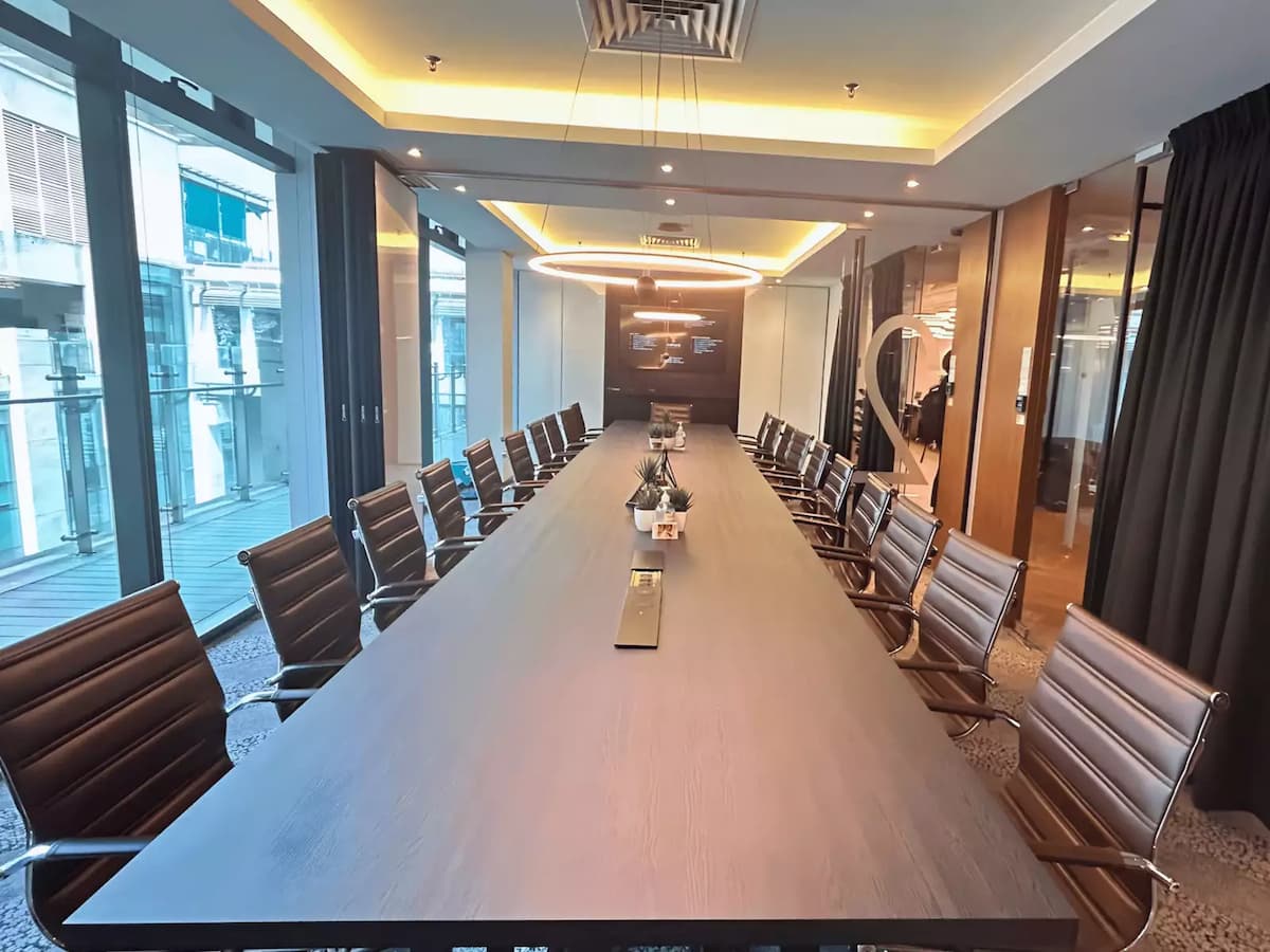 twenty seat conference table lit by natural daylight beside a balcony at a business event venue near klcc kuala lumpur