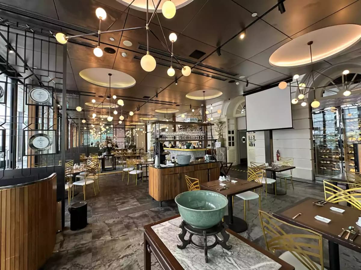 Stylish restaurant interior with open kitchen and ambient lighting.