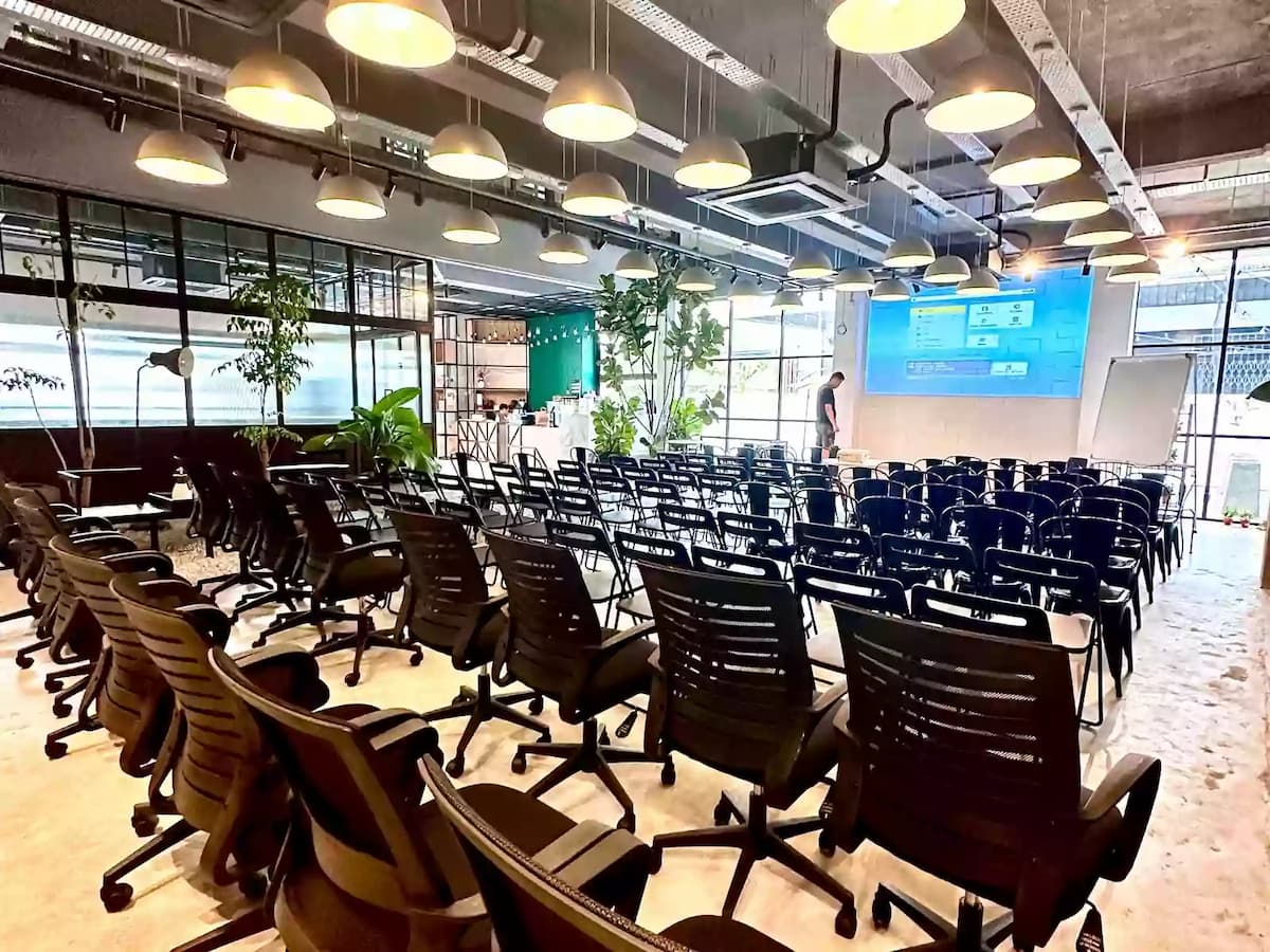 theatre style seating under warm pendant lights in a daylit conference space in bandar sunway malaysia