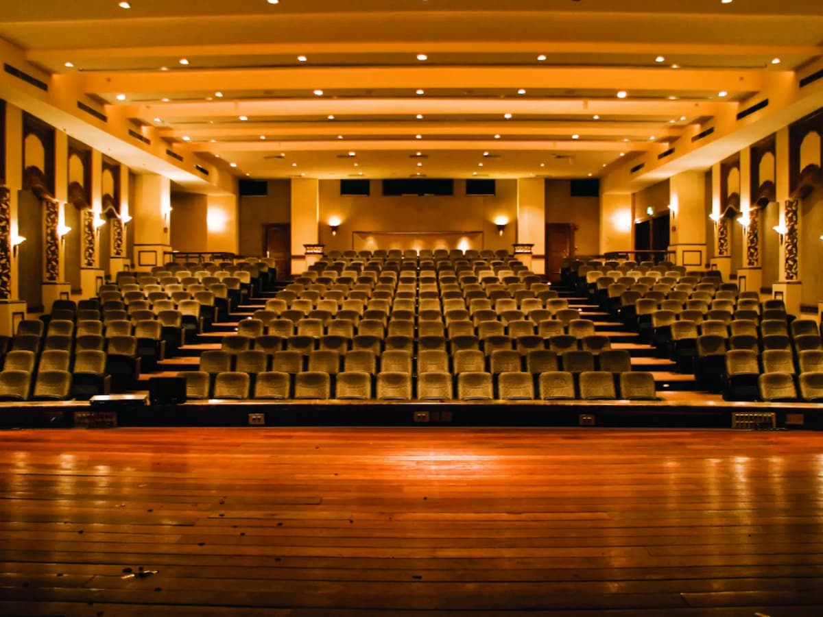 Large theatre-style auditorium with tiered seating and a wide stage view—ideal for performances, conferences, lectures, and large audience presentations.