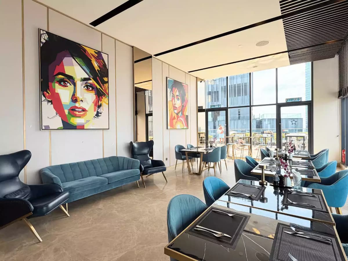 indoor private dining area with velvet sofas and pop art paintings at a sky lounge corporate event space in klcc kuala lumpur