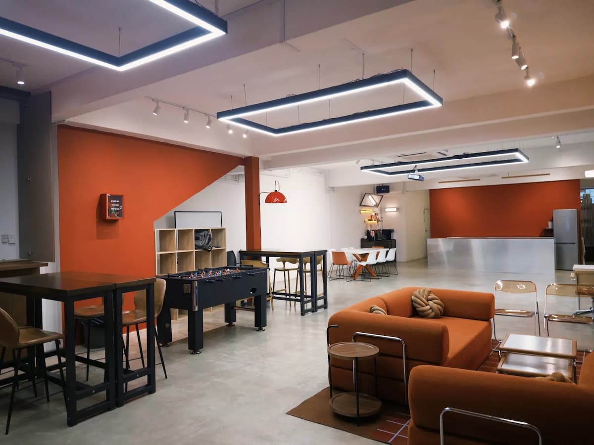 Modern lounge-style event space with foosball table and casual seating area.