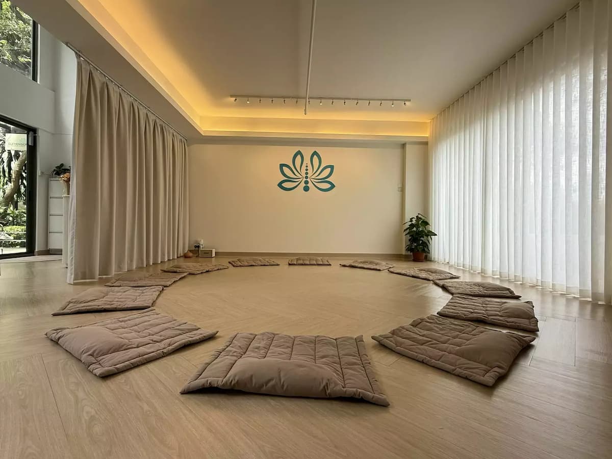 floor cushions arranged in a circle for meditation session at wellness event venue in kuala lumpur
