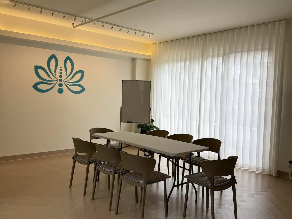 long table with eight chairs and whiteboard for small meeting at event space in bangsar south