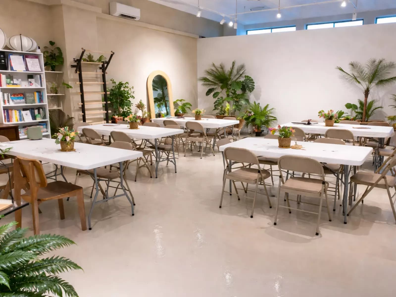 Bright workshop space with table seating and indoor plants.