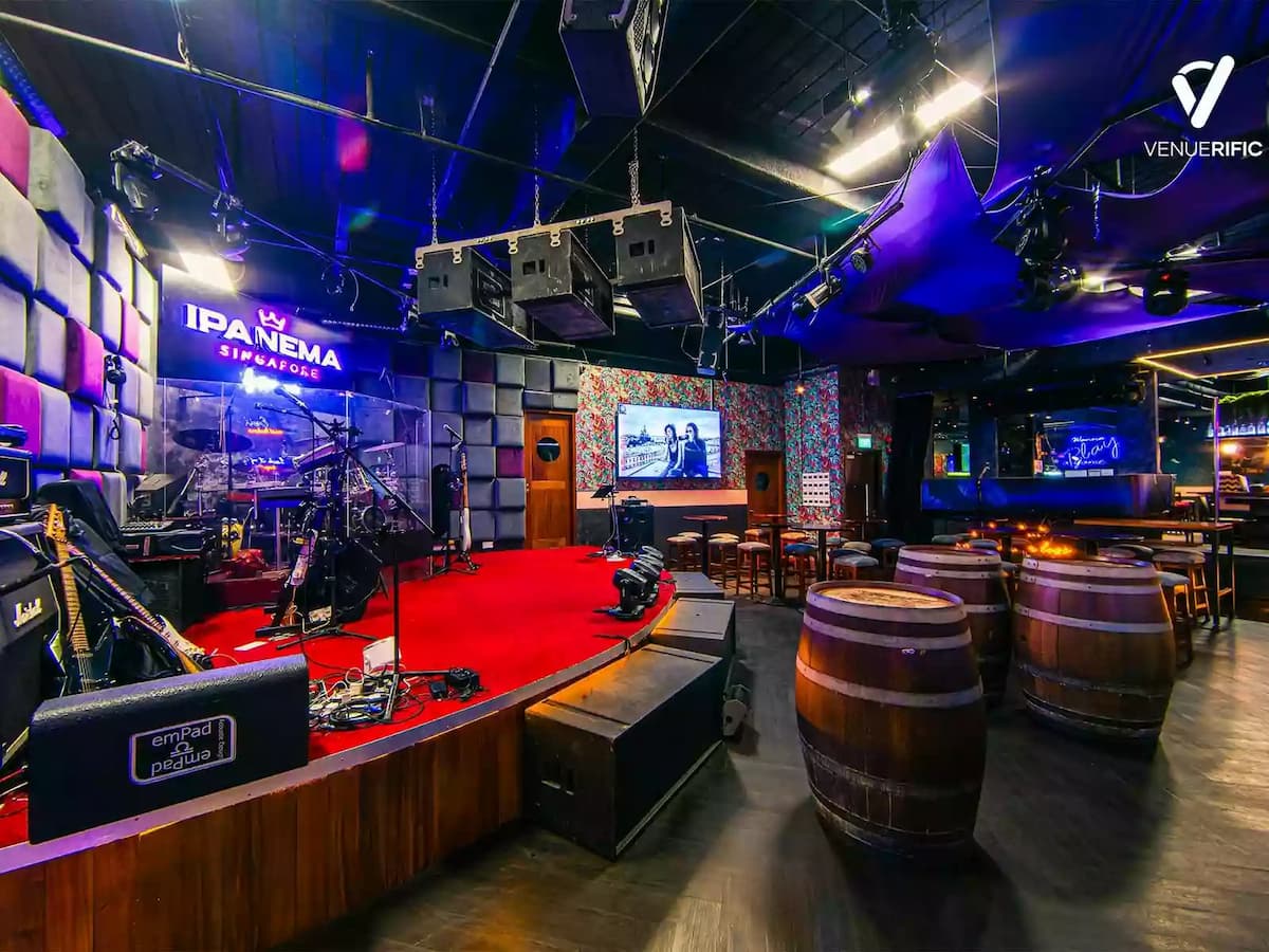 Live music stage with sound system and intimate event seating.