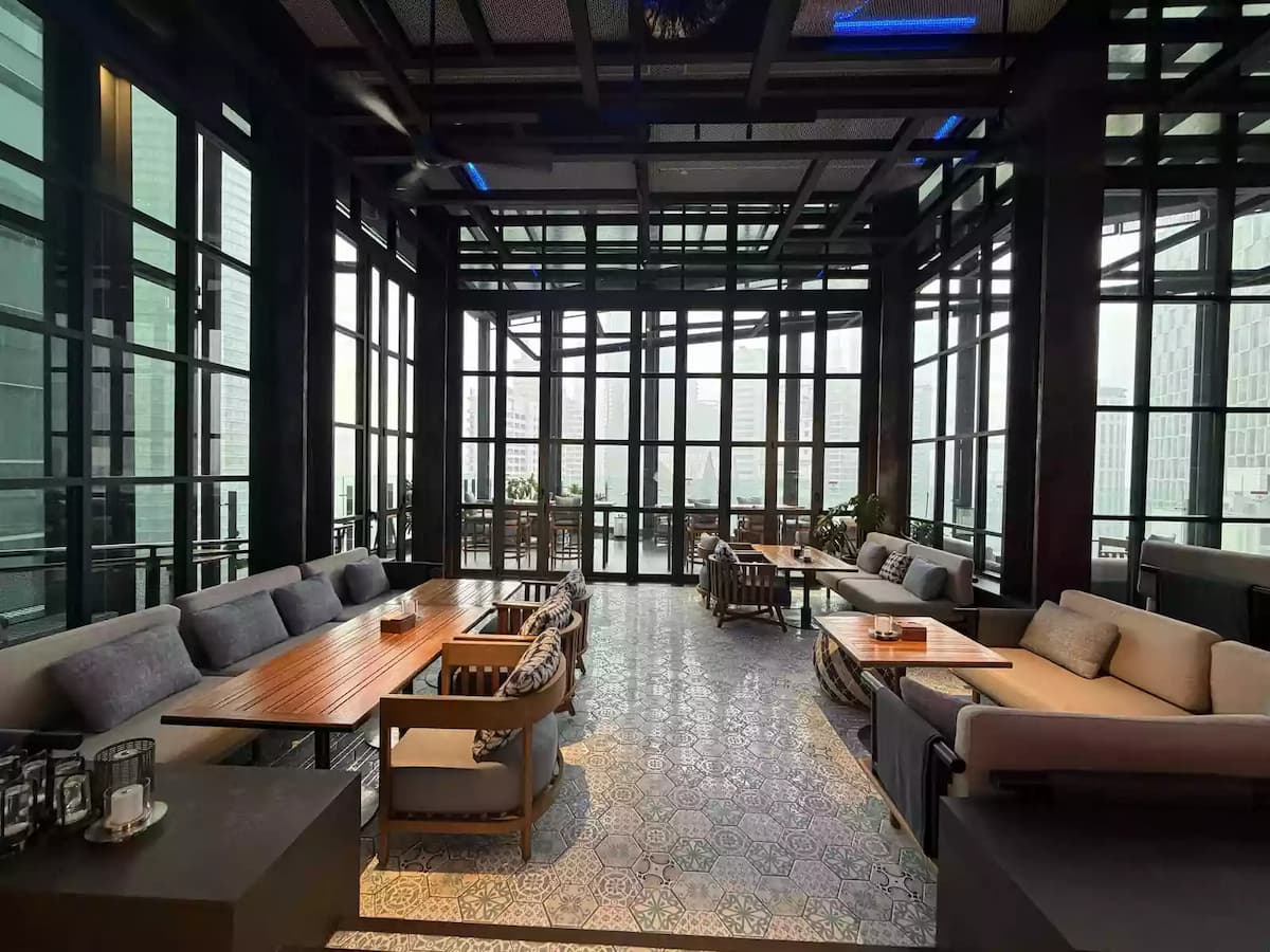 lounge seating with patterned tile floor and city view at social lounge private dining event space in kuala lumpur