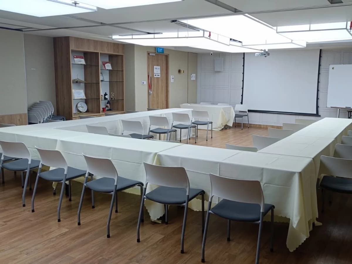 hollow square table setup with white tablecloths arranged for workshop meeting at north bridge road singapore