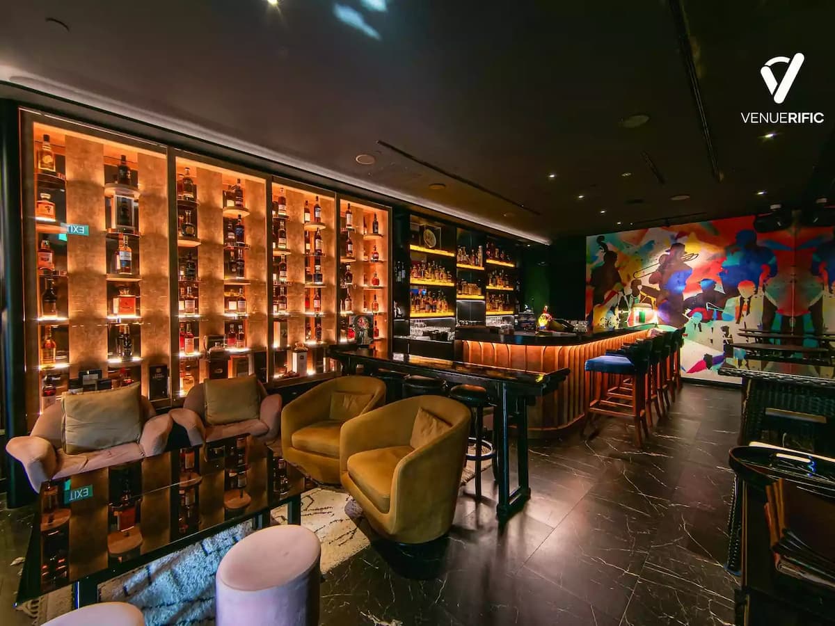 Premium whisky lounge at Maduro featuring an illuminated whisky wall, elegant lounge seating, a stylish cocktail bar, and sophisticated interiors, ideal for executive networking, private whisky tastings, cocktail receptions, and exclusive corporate events.