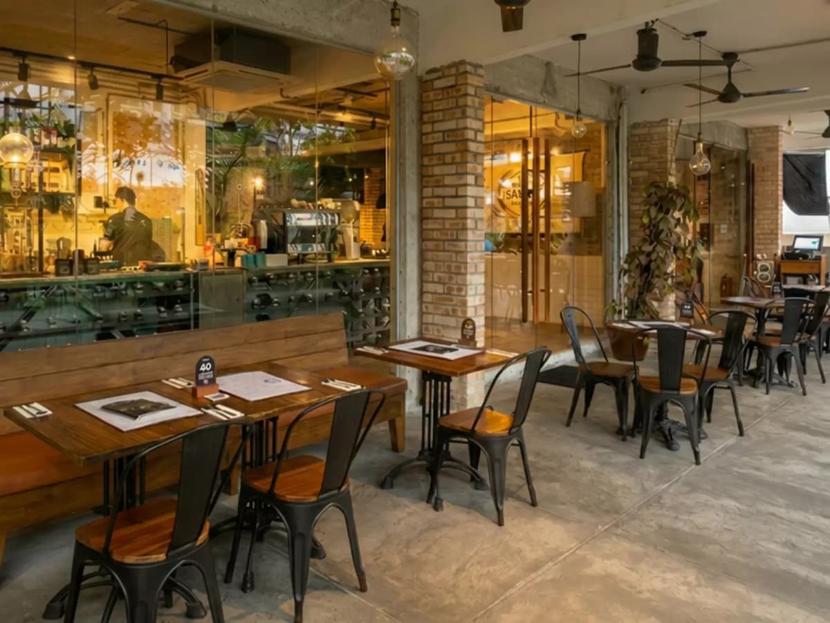 Industrial-style café with indoor-outdoor seating, exposed brick accents, and a relaxed atmosphere for casual dining and private events.