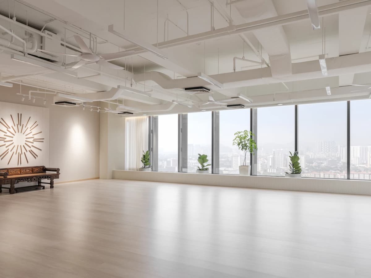 Bright multipurpose event studio with floor-to-ceiling windows, open-plan layout, and minimalist interiors, ideal for workshops, yoga classes, wellness sessions, corporate meetings, and private events.
