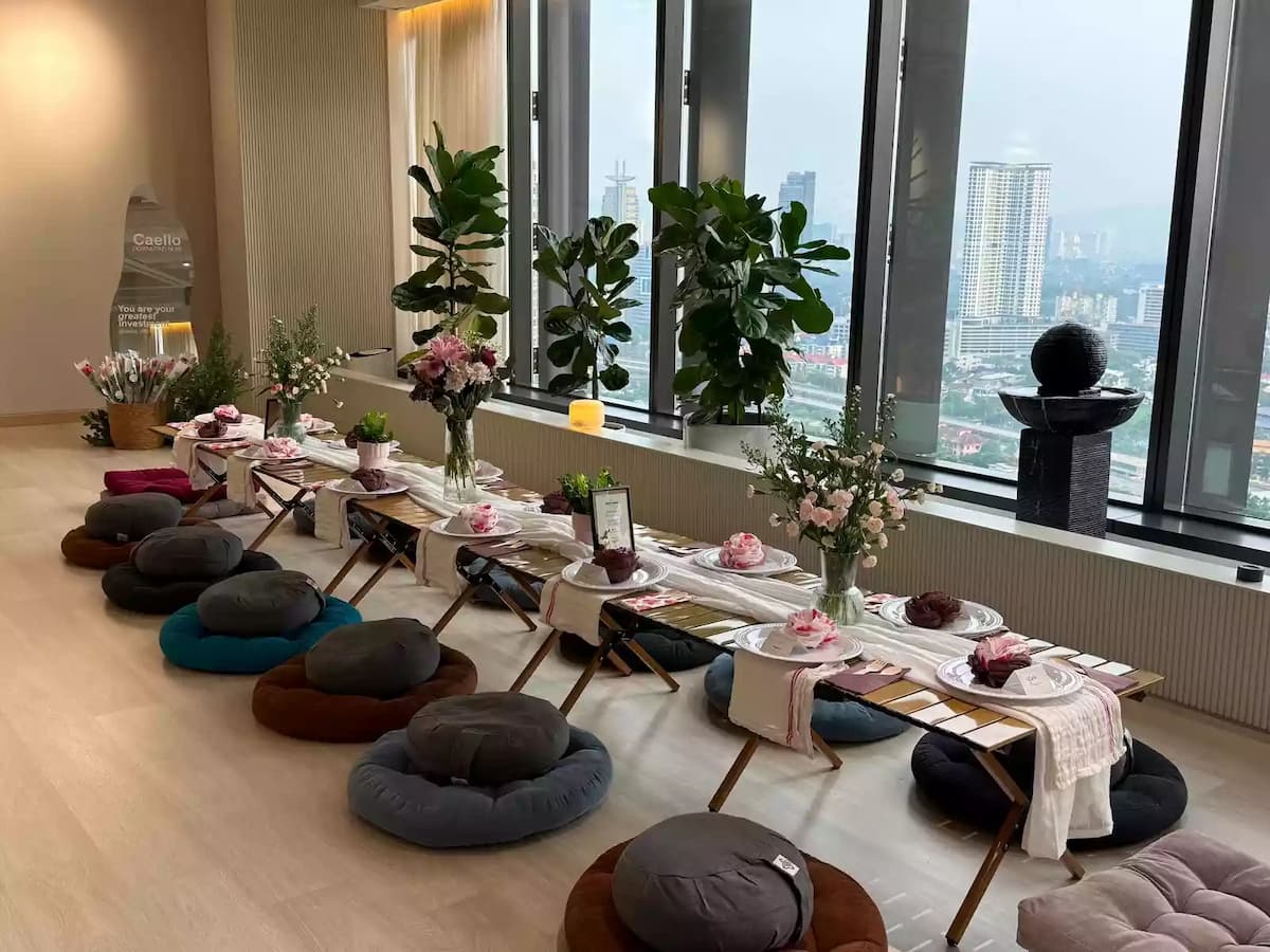Bright city-view event space styled for a wellness workshop with floor seating, low tables, and elegant décor, ideal for mindfulness sessions, corporate wellness programs, creative workshops, and private gatherings.
