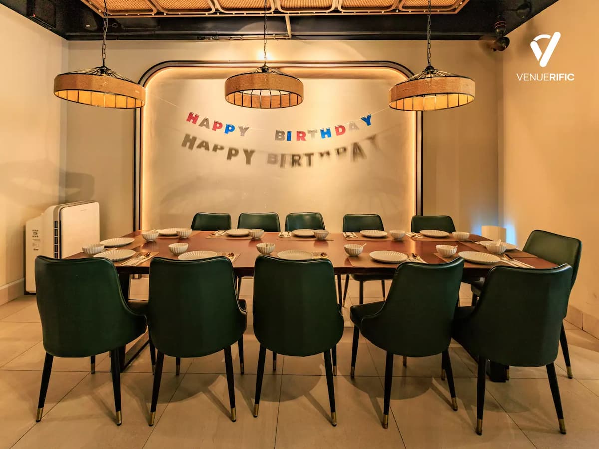 Private dining with a long banquet table, warm ambient lighting, and an intimate setting, perfect for birthday celebrations, corporate dinners, family gatherings, and private events.