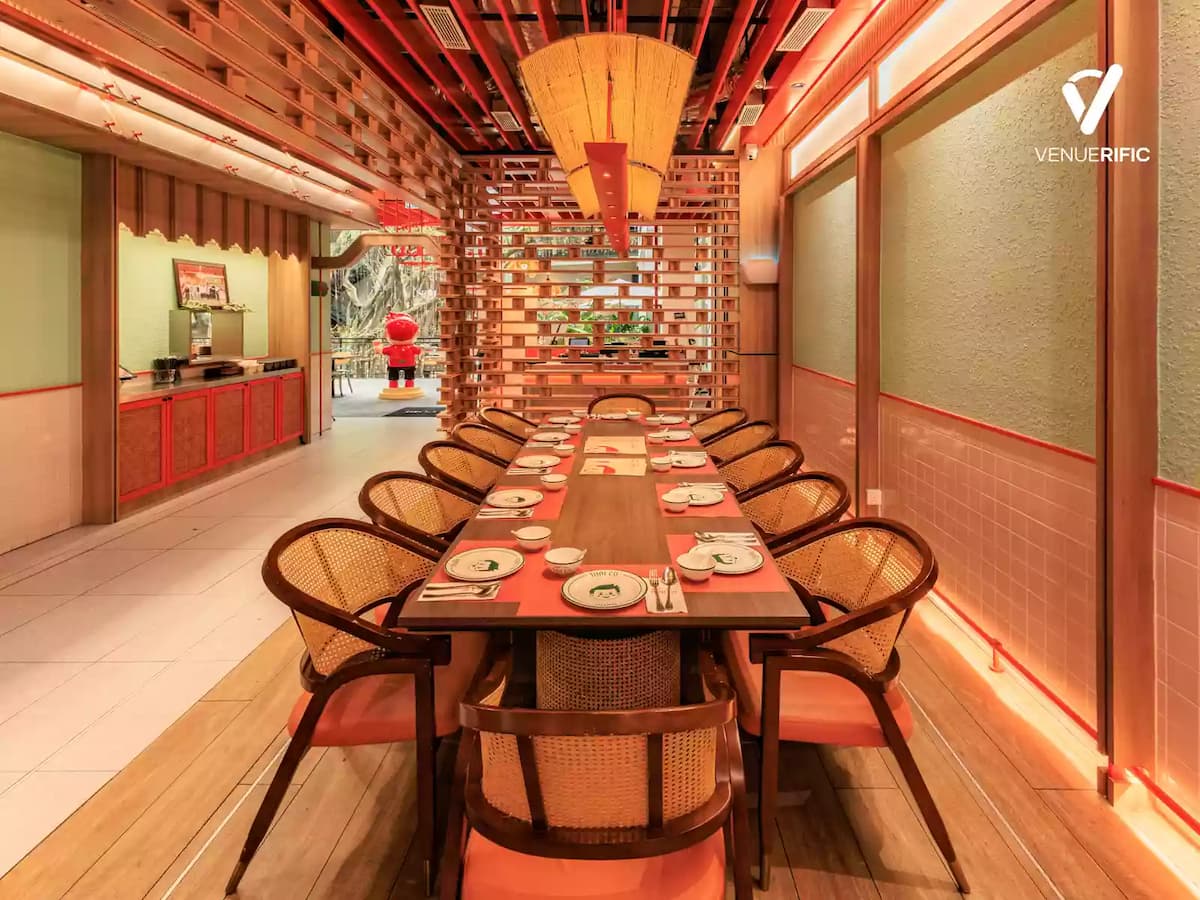 Elegant private Thai dining room with a long communal table, warm oriental-inspired décor, and semi-private seating, perfect for business dinners, corporate gatherings, family celebrations, and private events.