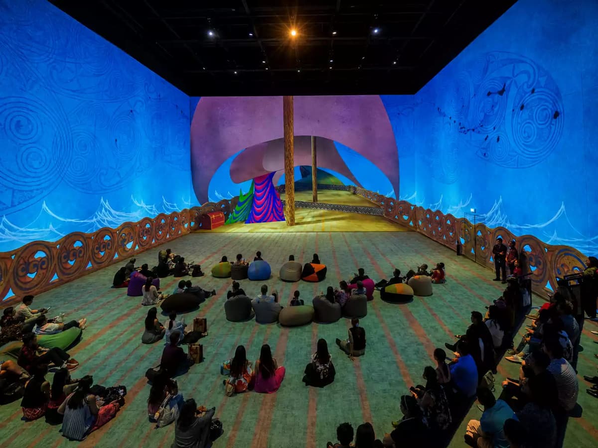 guests seated on bean bags watching an immersive blue projection show at imba theatre event space in singapore