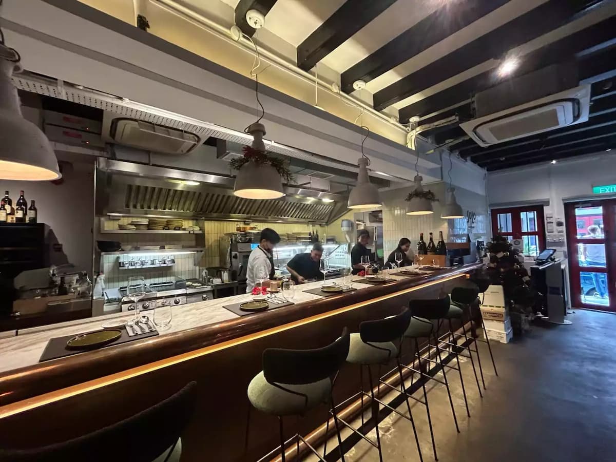open kitchen and counter seating inside solo ristorante italian restaurant in singapore