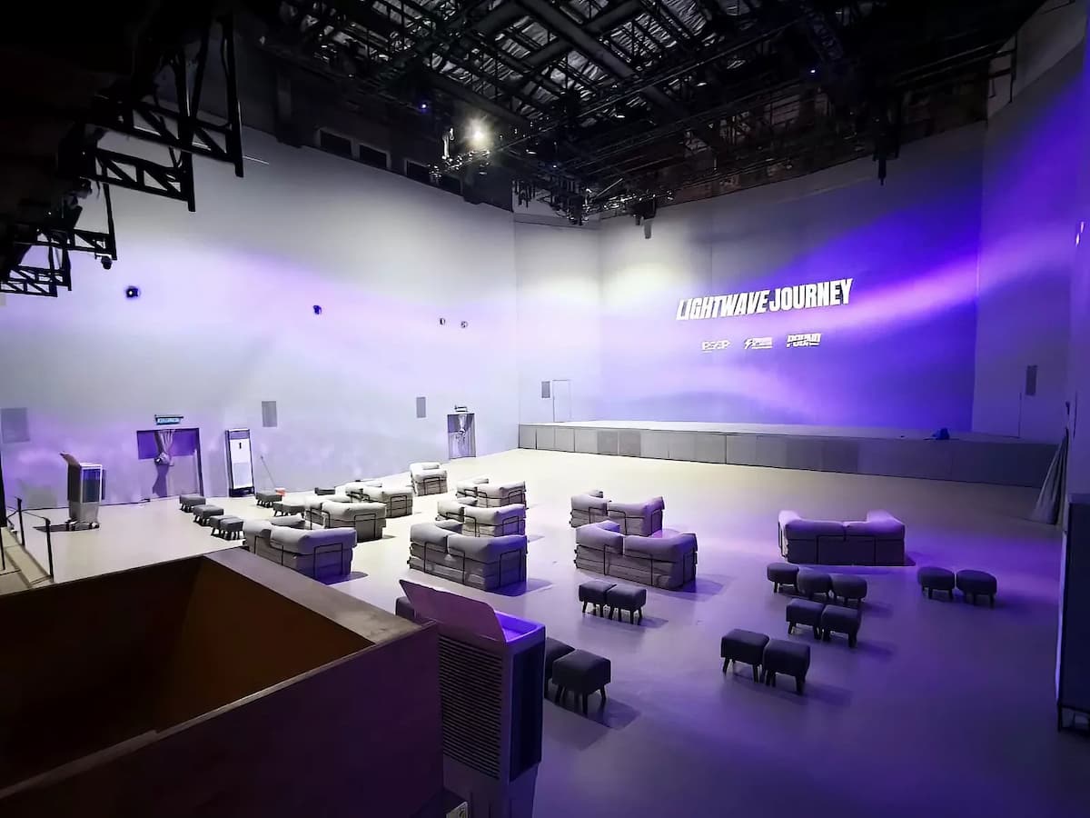 purple and white illuminated event space with modular seating furniture setup at the experience venue in kuala lumpur