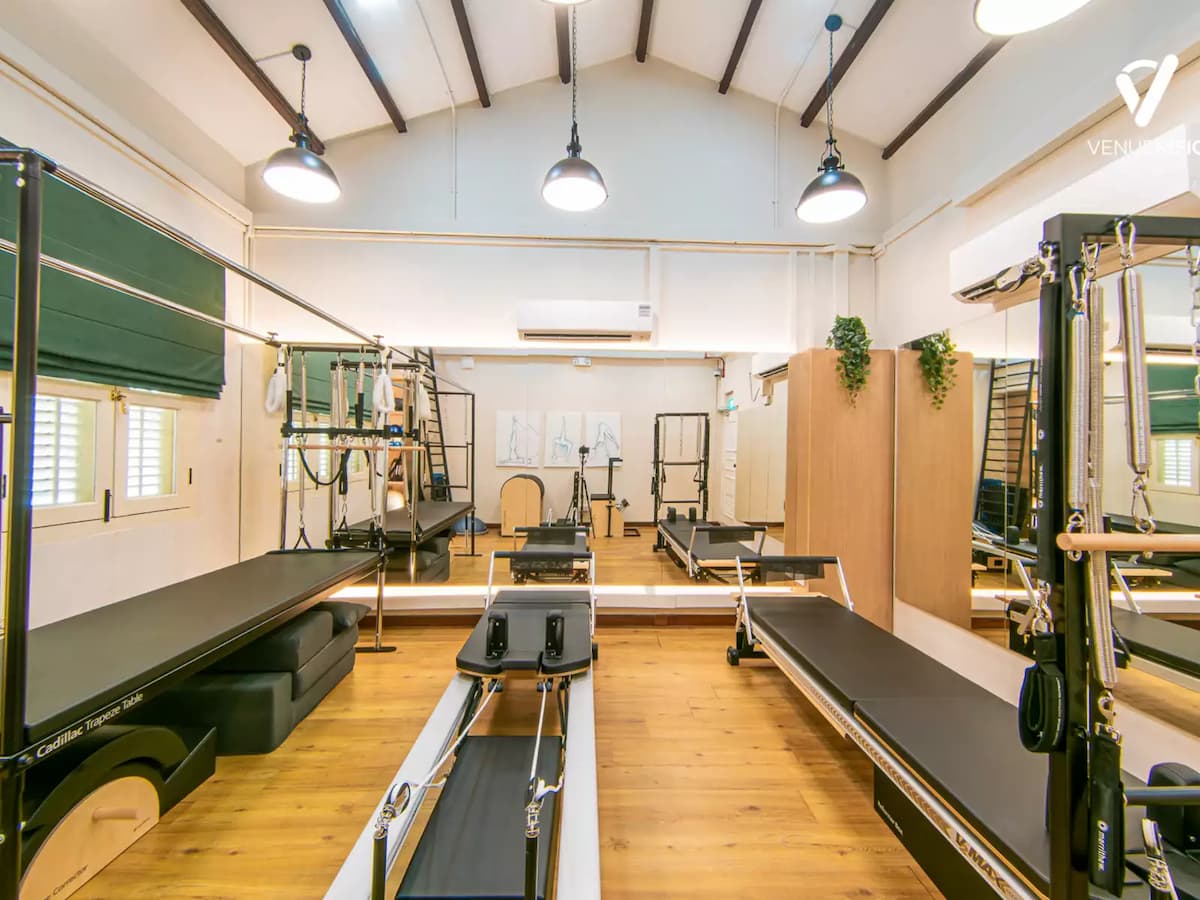 private pilates studio with reformer equipment and mirrors at the experience exchange in singapore
