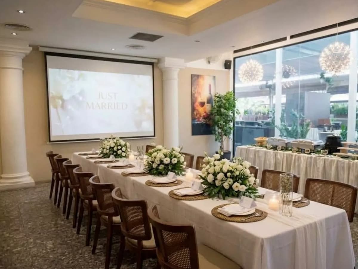 wedding reception table with white floral arrangements at lebua thai event venue in chijmes singapore