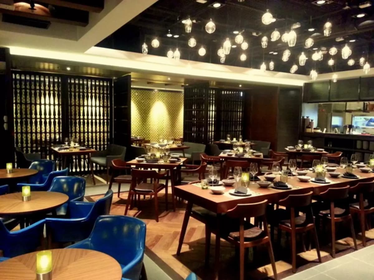 main dining area with hanging lightbubs on ceiling