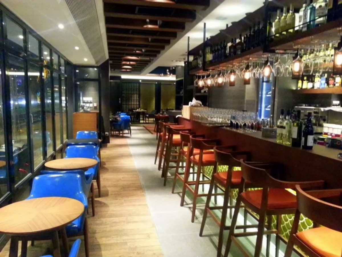 bar and high chairs in restaurants with hanging glasses