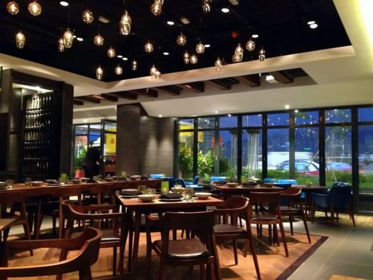 wooden furnitures in restaurant; decorative hanging light bulbs