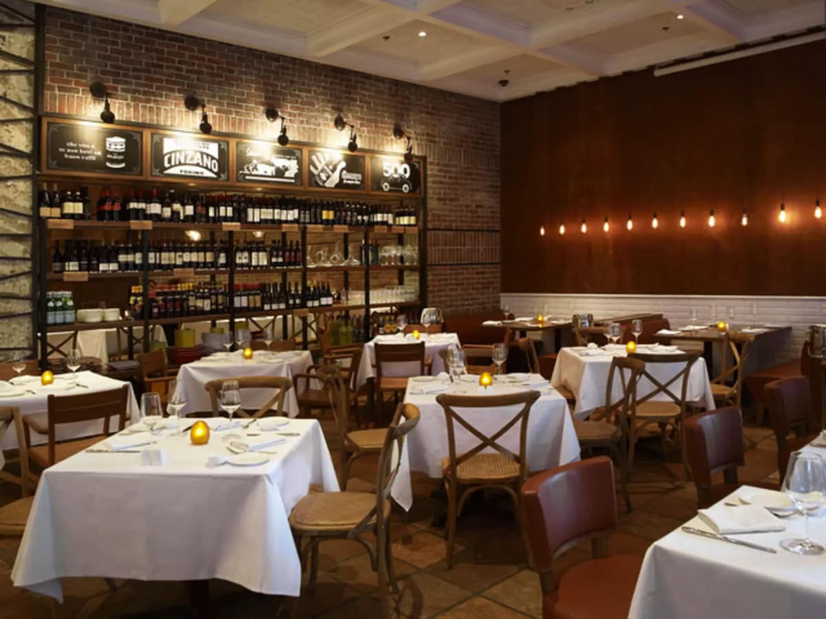 red brick walls, vintage blackboards with rustic shades at the main dining area