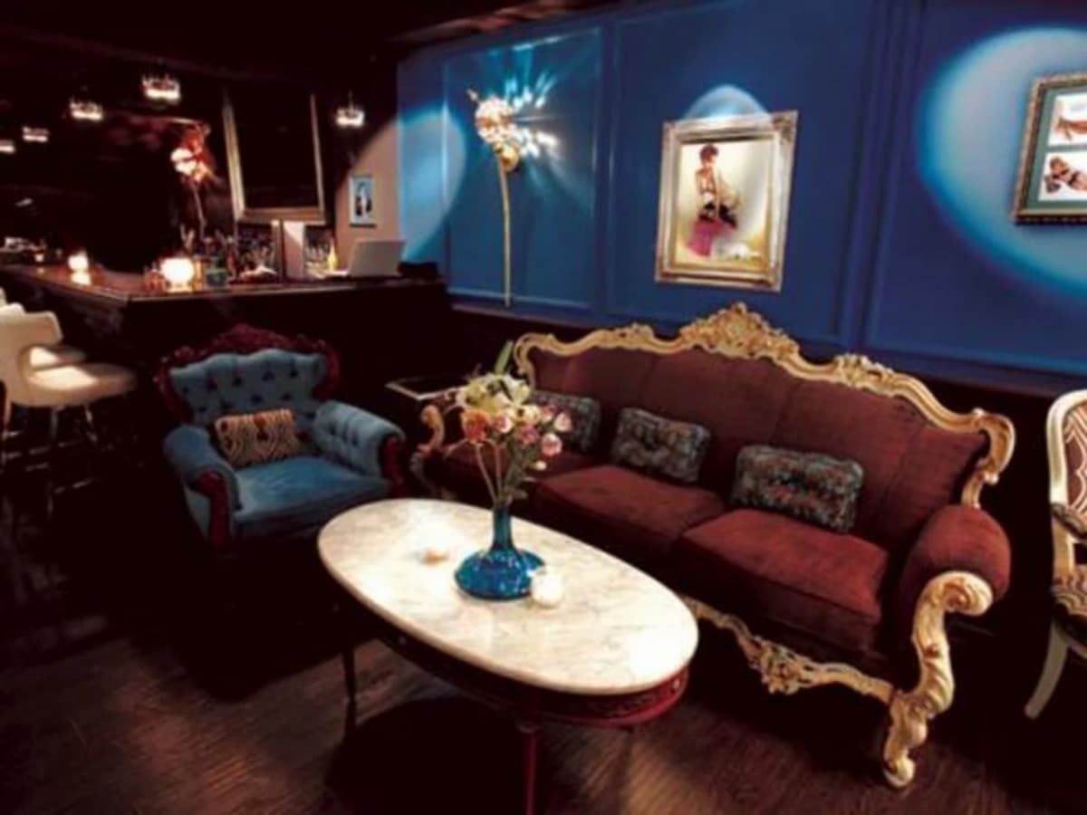 artistic lounge area with a lot of paintings on the wall