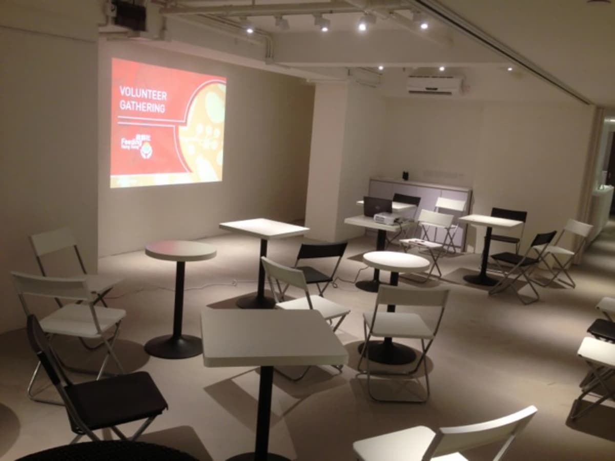 small tables for breakout sessions equipped with projector screen in event space
