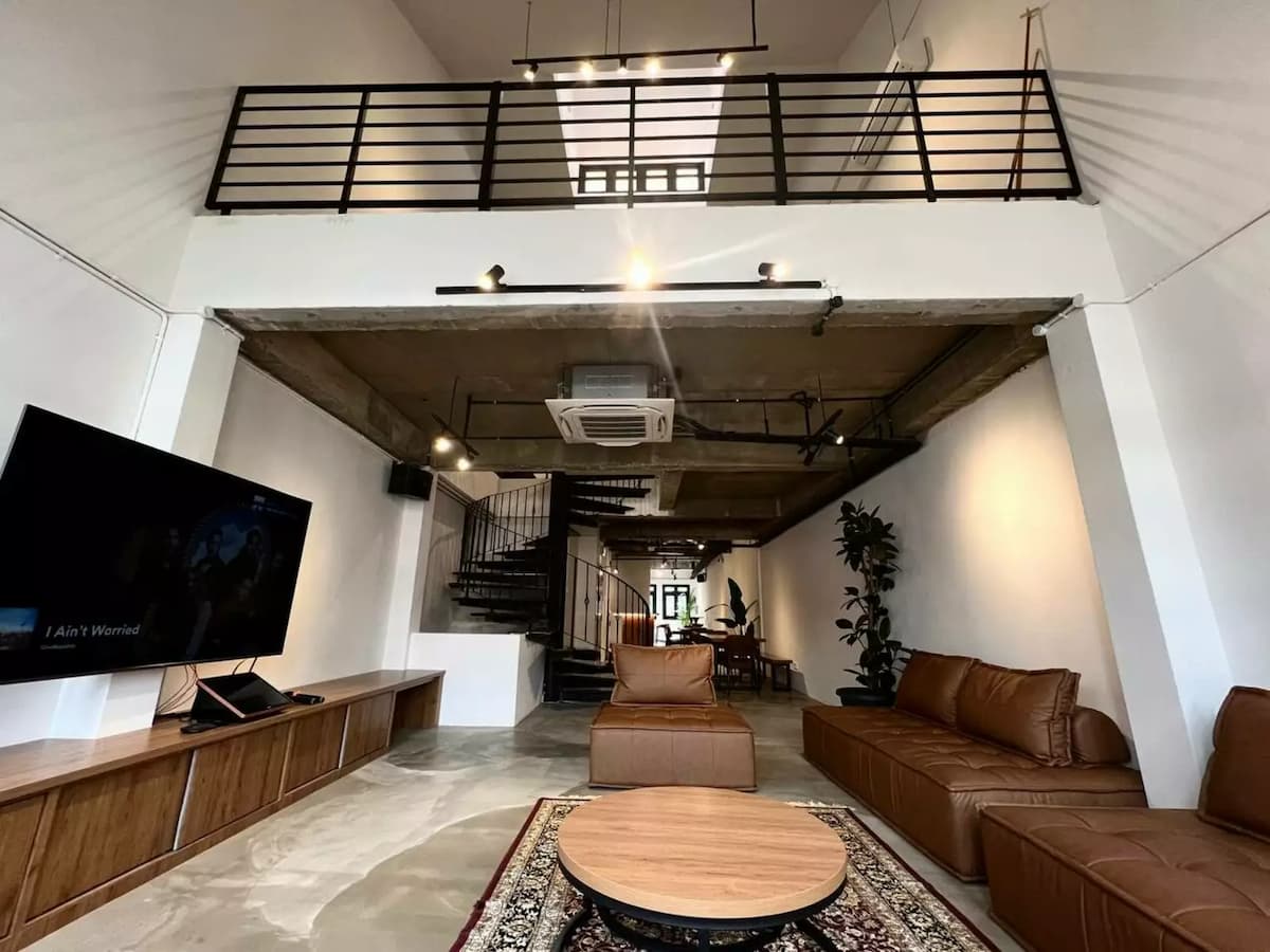 private party event space with brown couches and tv in living room