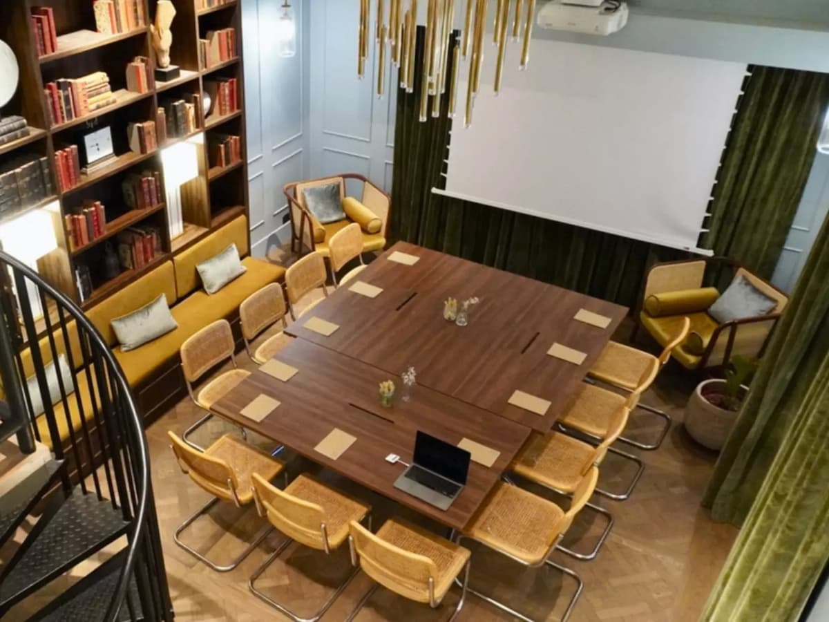aerial view of a large meeting room with a projector and library